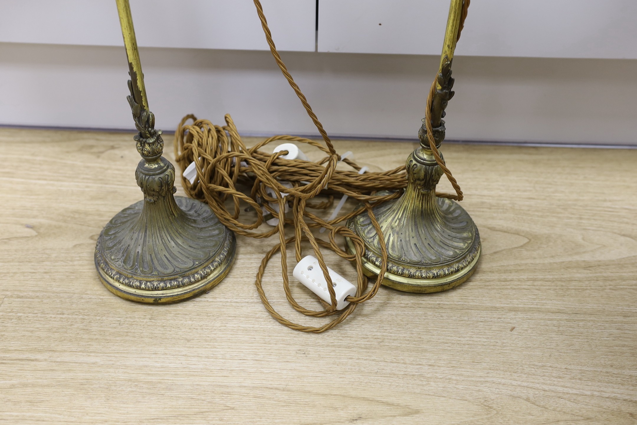 A pair of Louis XVI style gilt brass reading lamps, 66cm